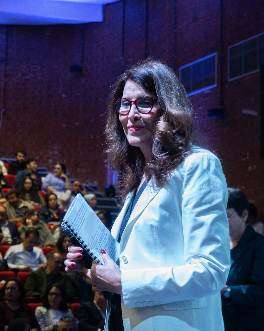Experienced executive speaking to a full conference audience